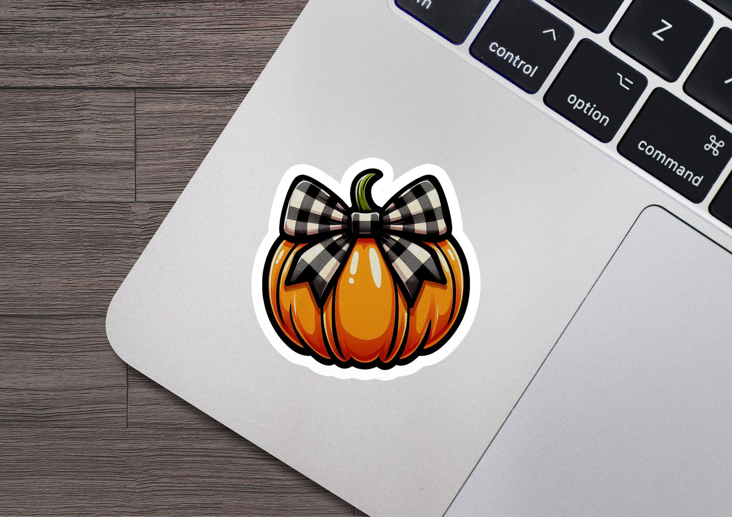 a sticker of a pumpkin with a bow on it