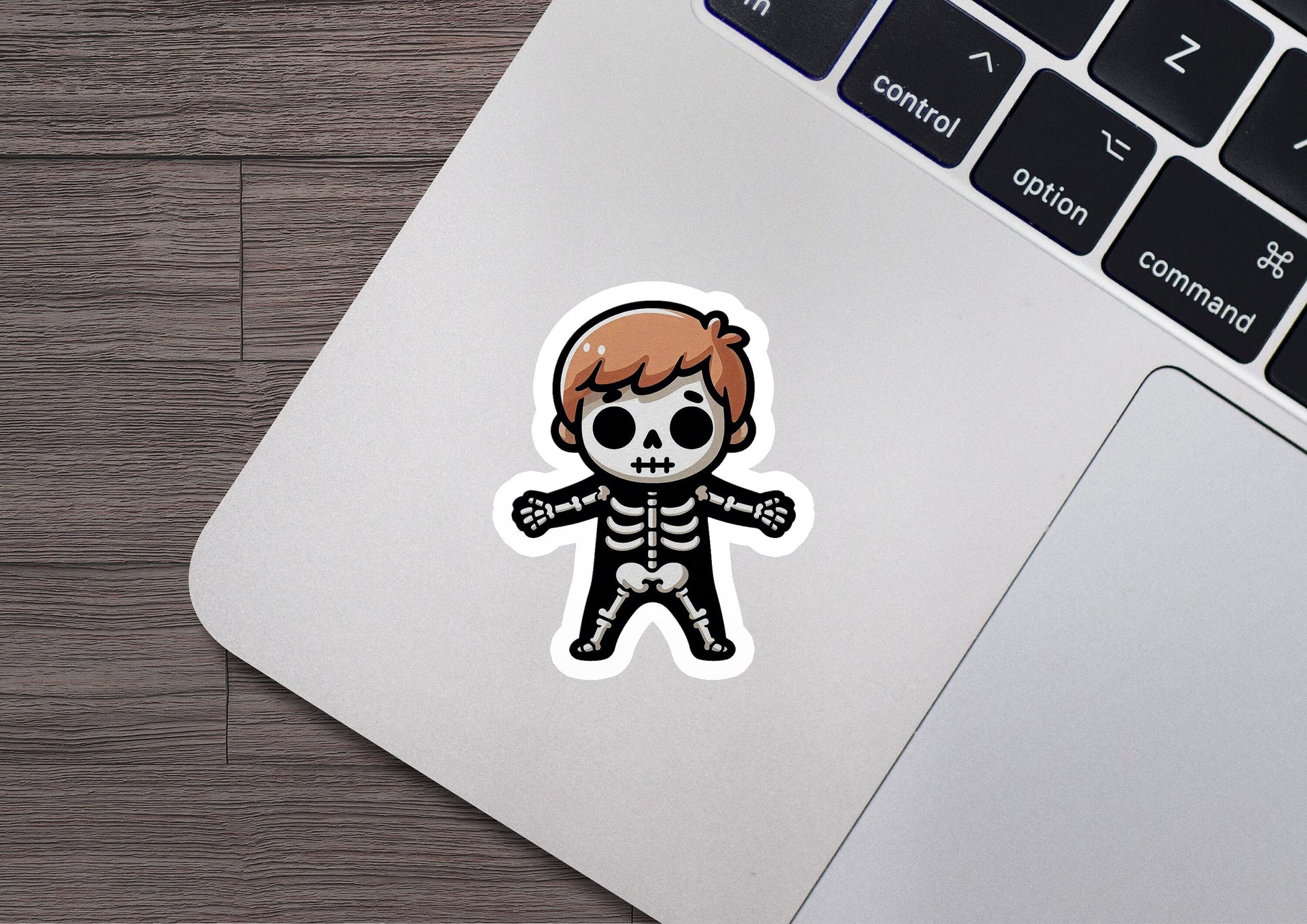 a laptop with a sticker of a skeleton on it