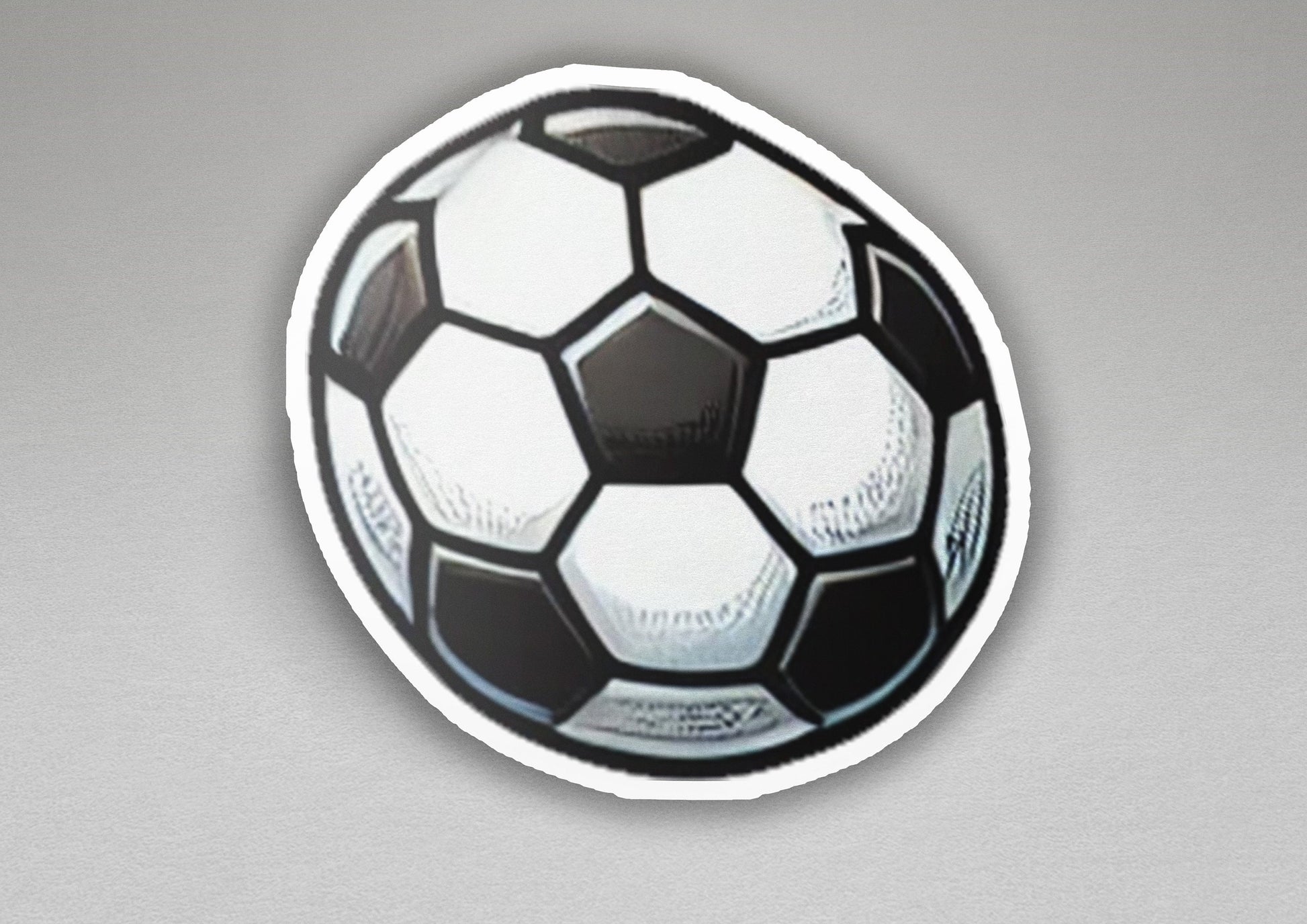 a black and white soccer ball on a gray background