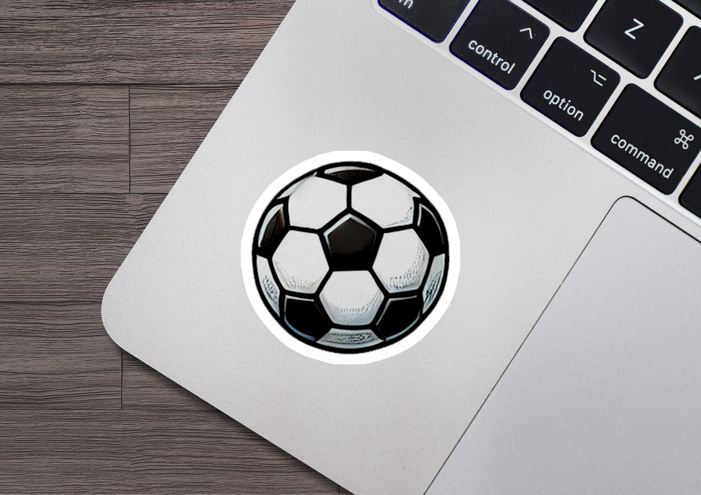 a sticker of a soccer ball on a laptop