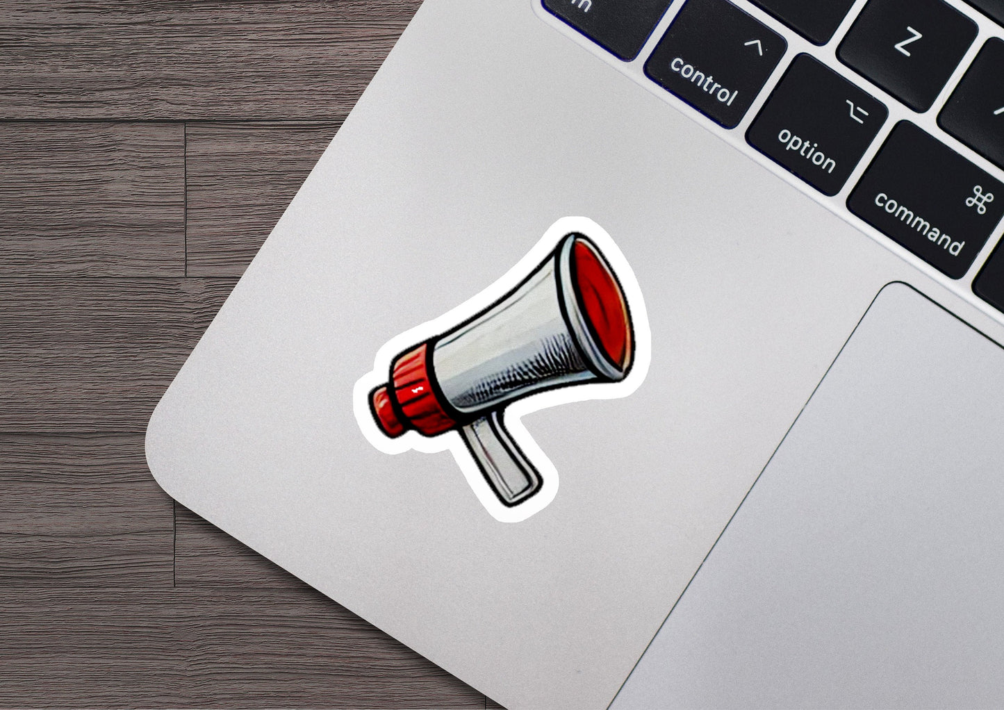 a sticker of a red and white megaphone on a laptop