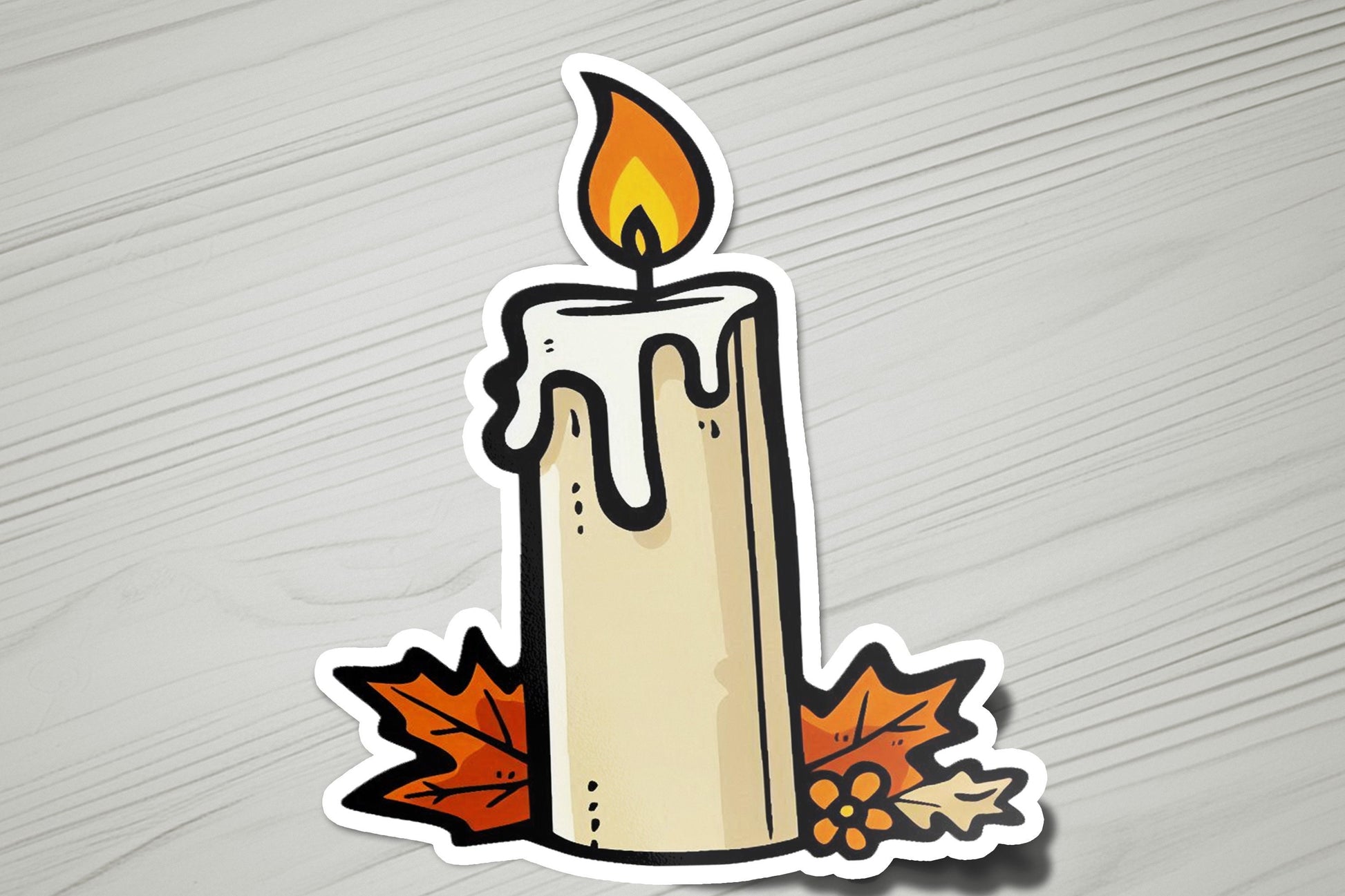 a sticker of a lit candle with autumn leaves