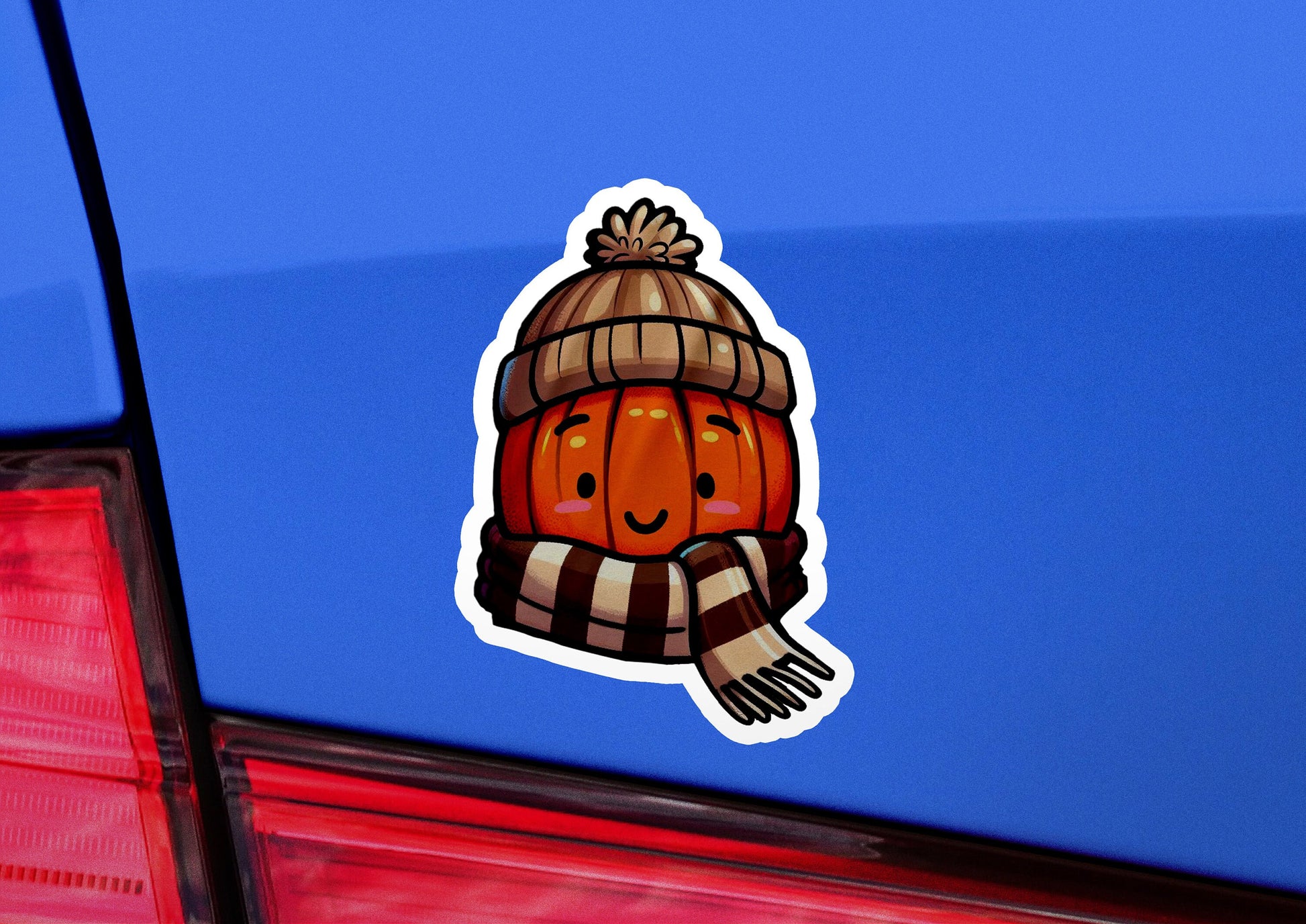 a sticker of a pumpkin wearing a scarf