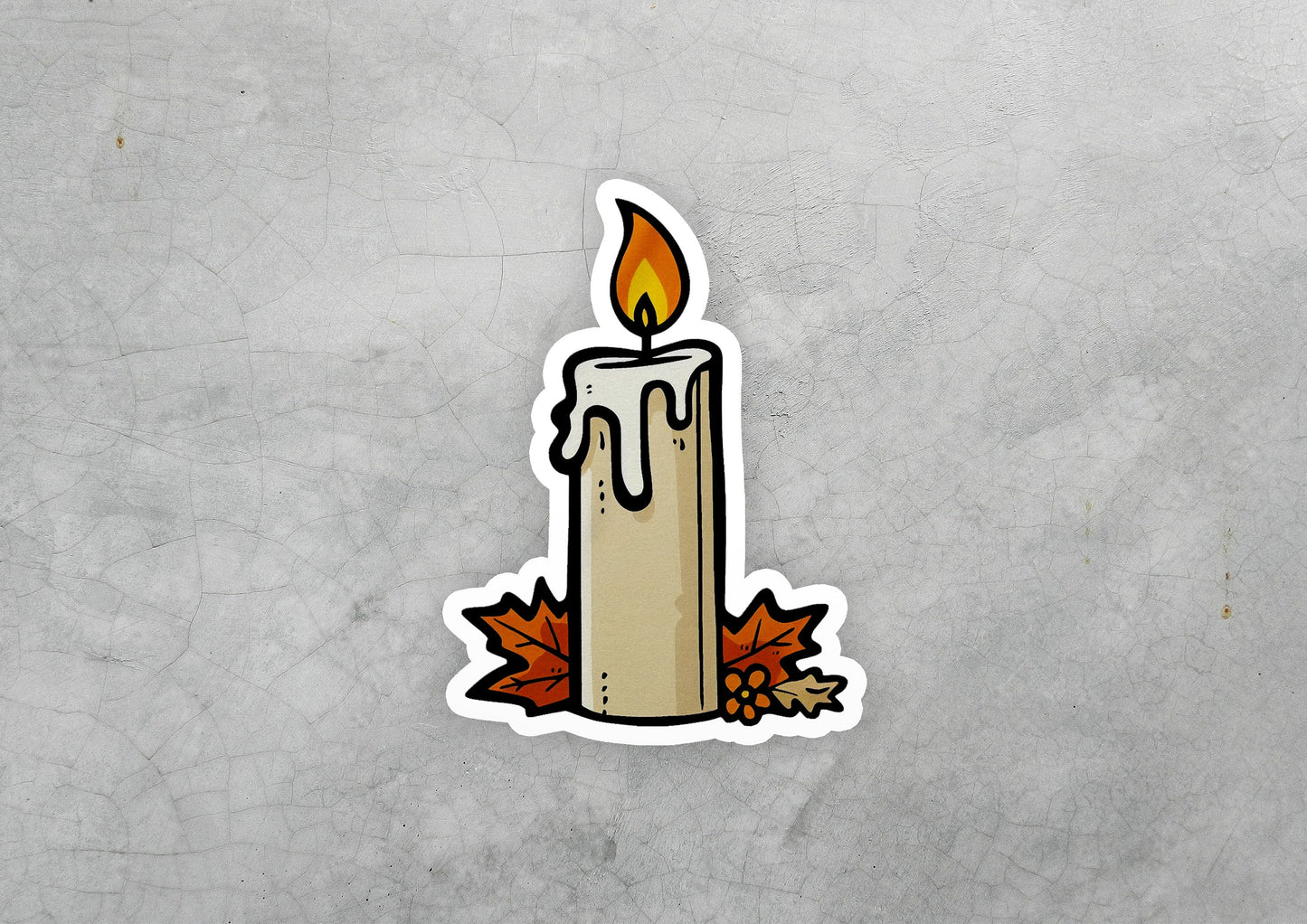 a sticker of a lit candle with autumn leaves