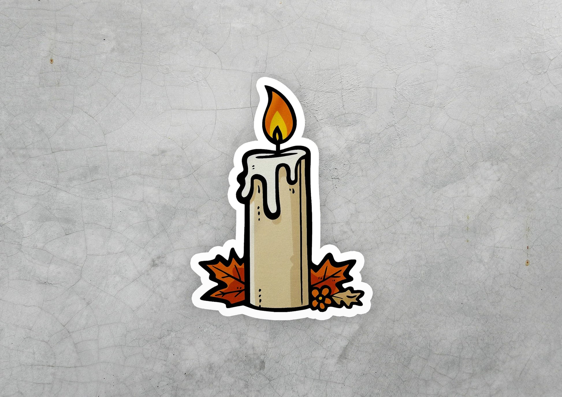 a sticker of a lit candle with autumn leaves