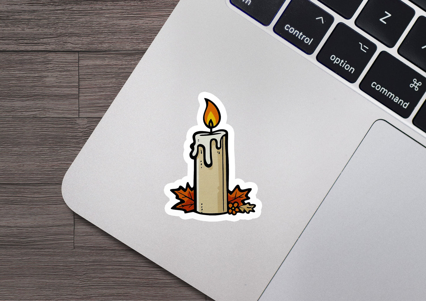 a sticker of a lit candle on a laptop