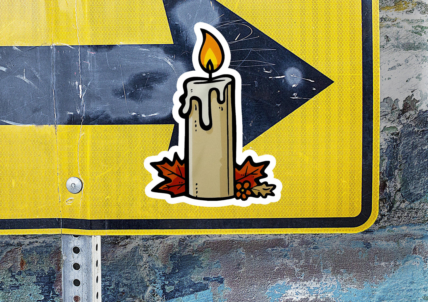 a sticker of a lit candle on a street sign