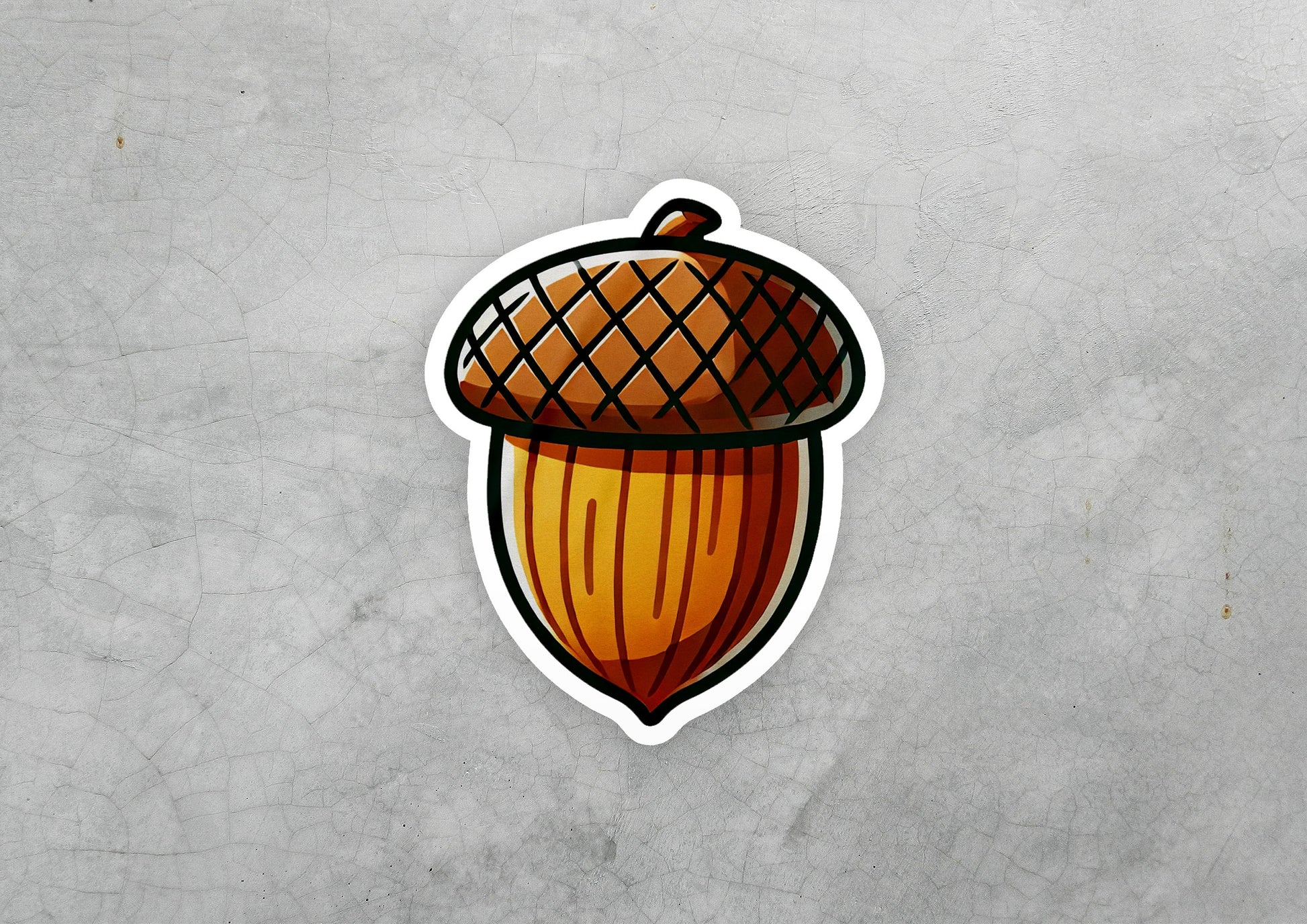 a sticker of an acorn on a gray background