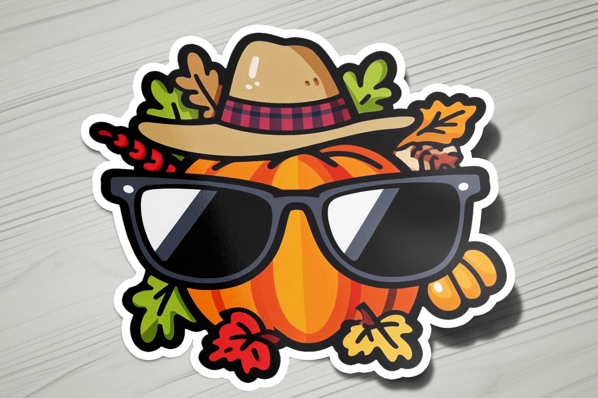 a sticker of a pumpkin wearing sunglasses and a hat