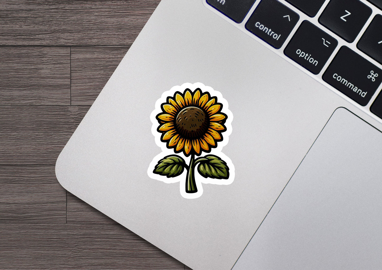 a sticker of a sunflower on a laptop