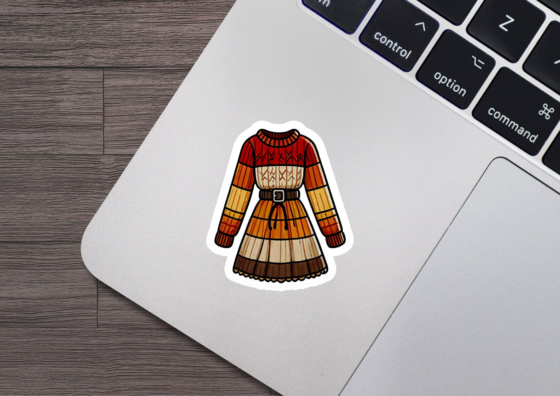 a laptop with a sticker of a sweater on it