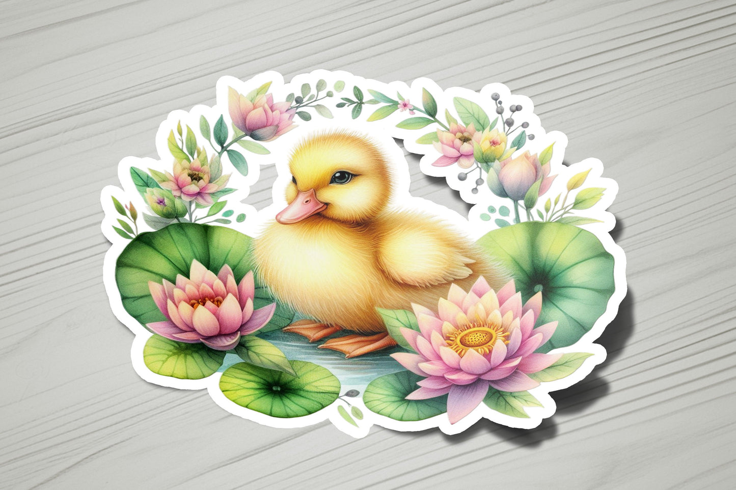 a sticker of a duckling sitting on a lily pad