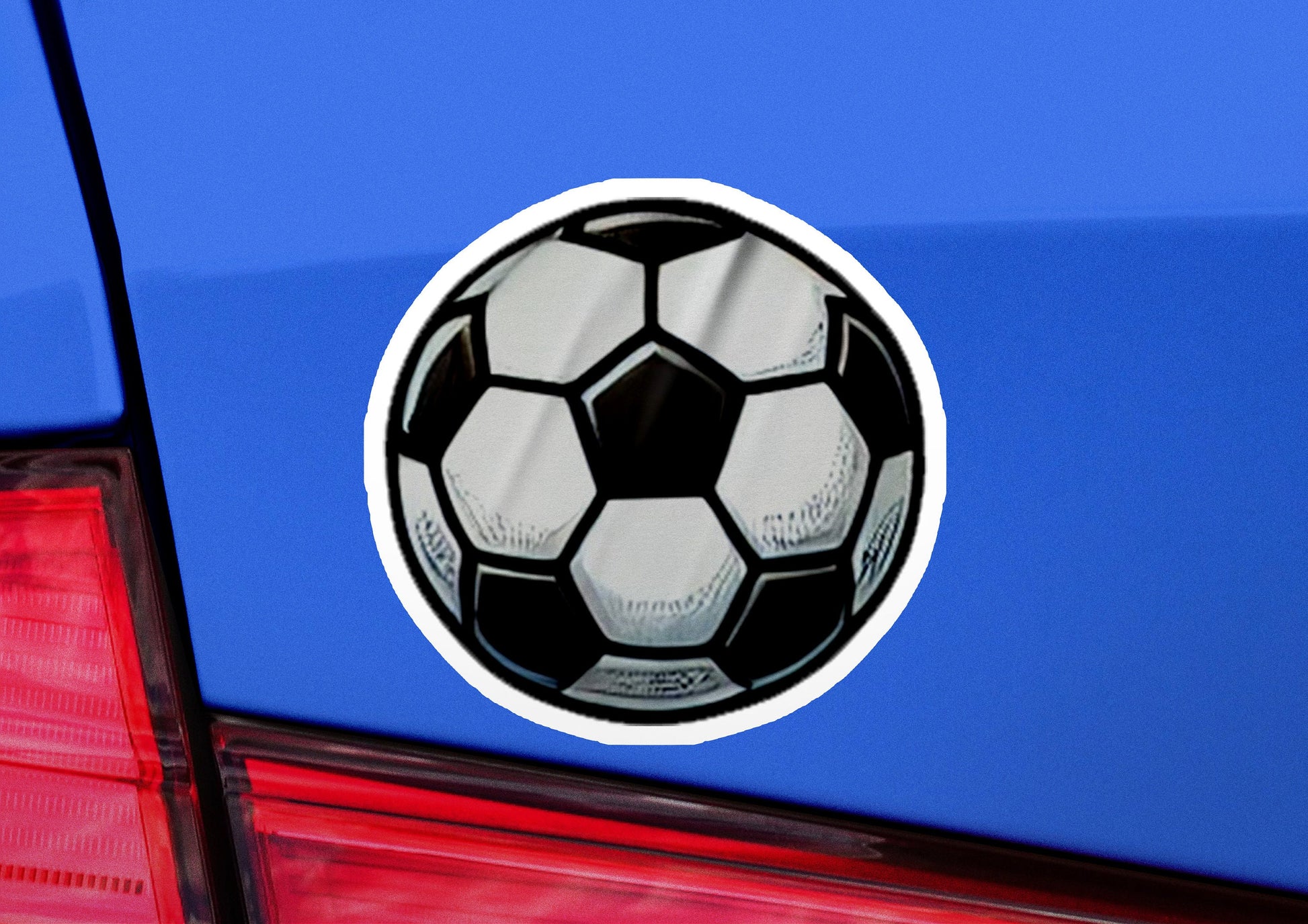 a soccer ball sticker on the back of a car