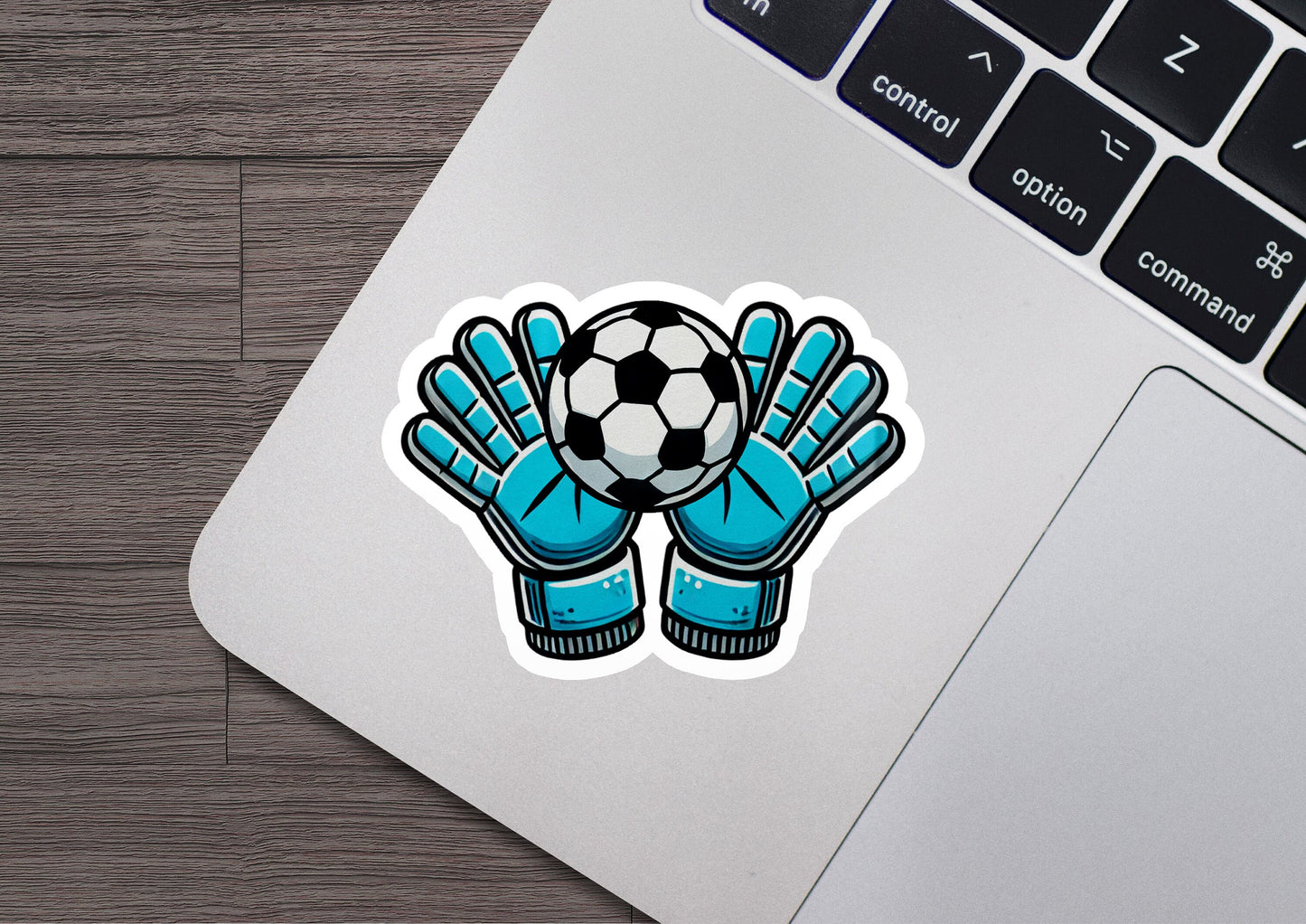 a sticker of a soccer ball and glove on a laptop