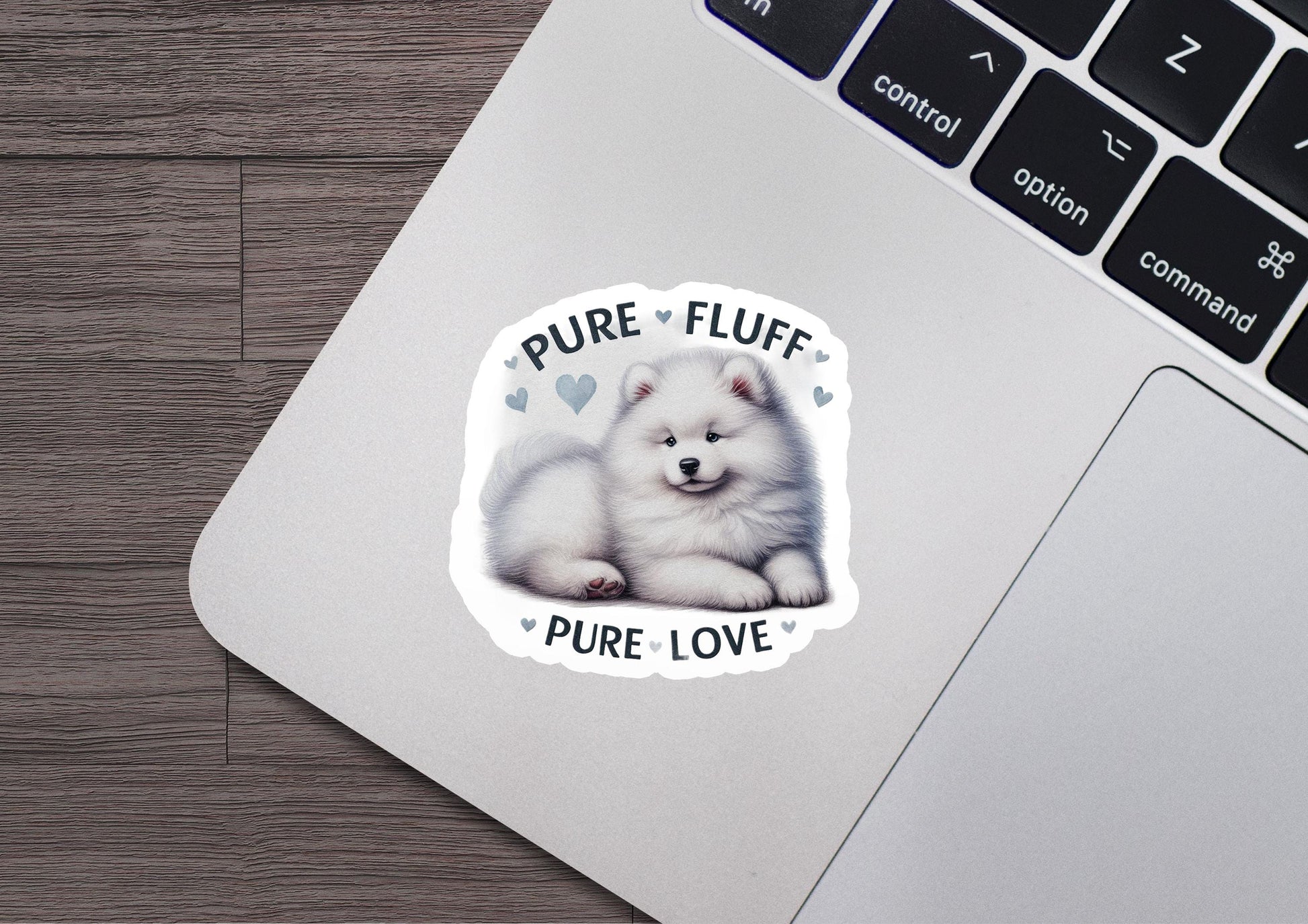 a sticker of a white fluffy dog on a laptop