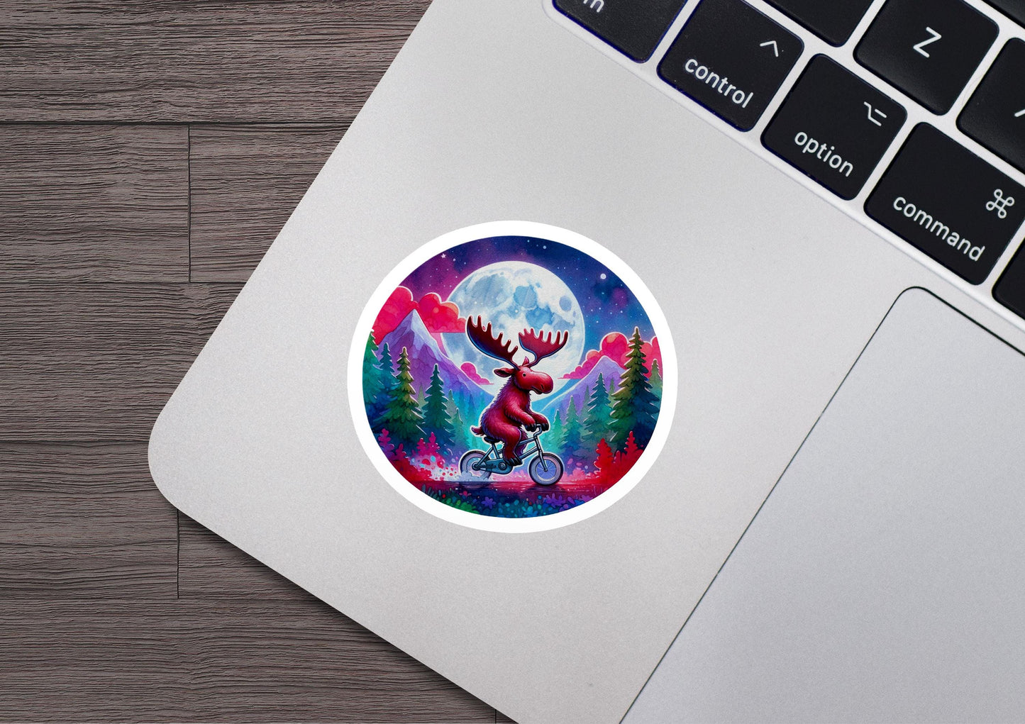 a laptop with a sticker of a moose riding a bike