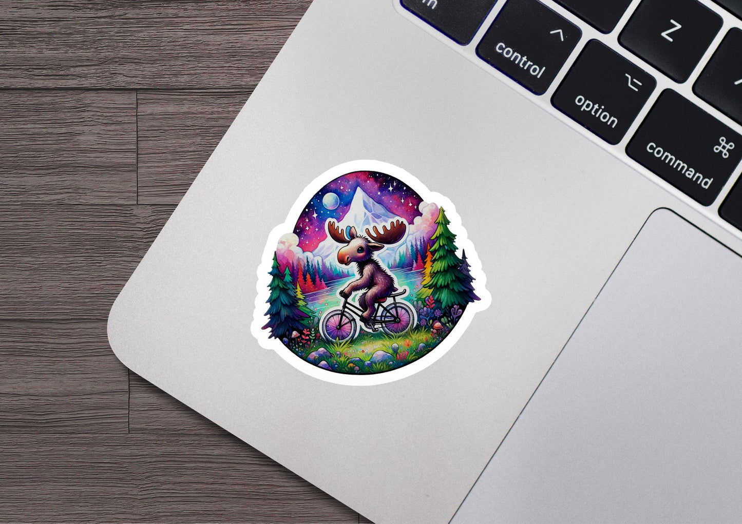 a laptop with a sticker of a moose riding a bike