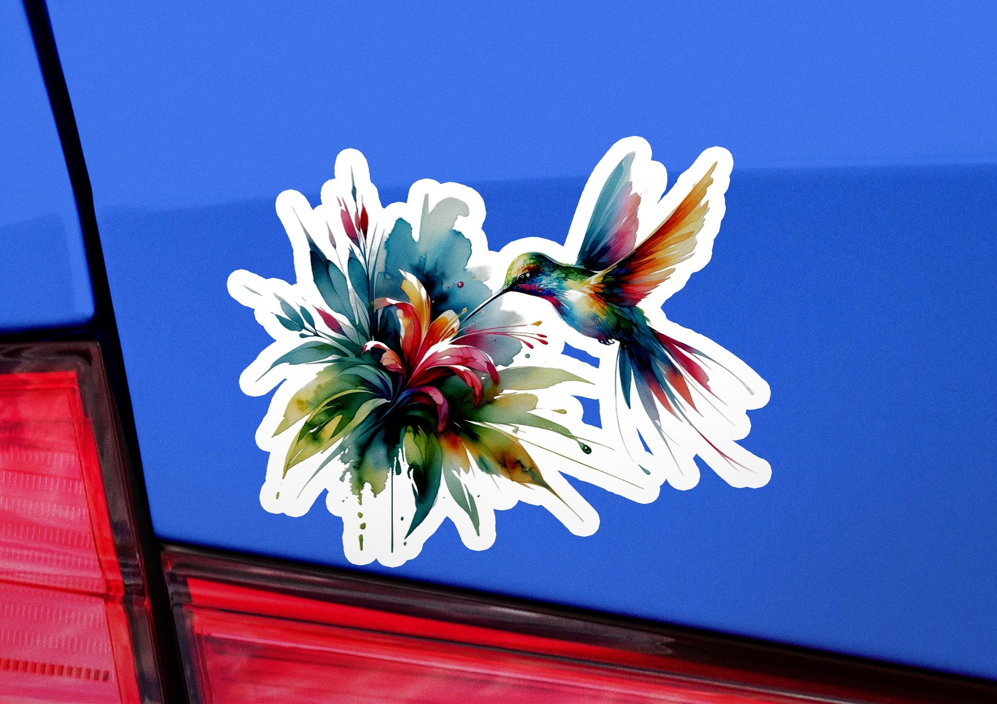 a sticker of a bird and flower on the back of a car