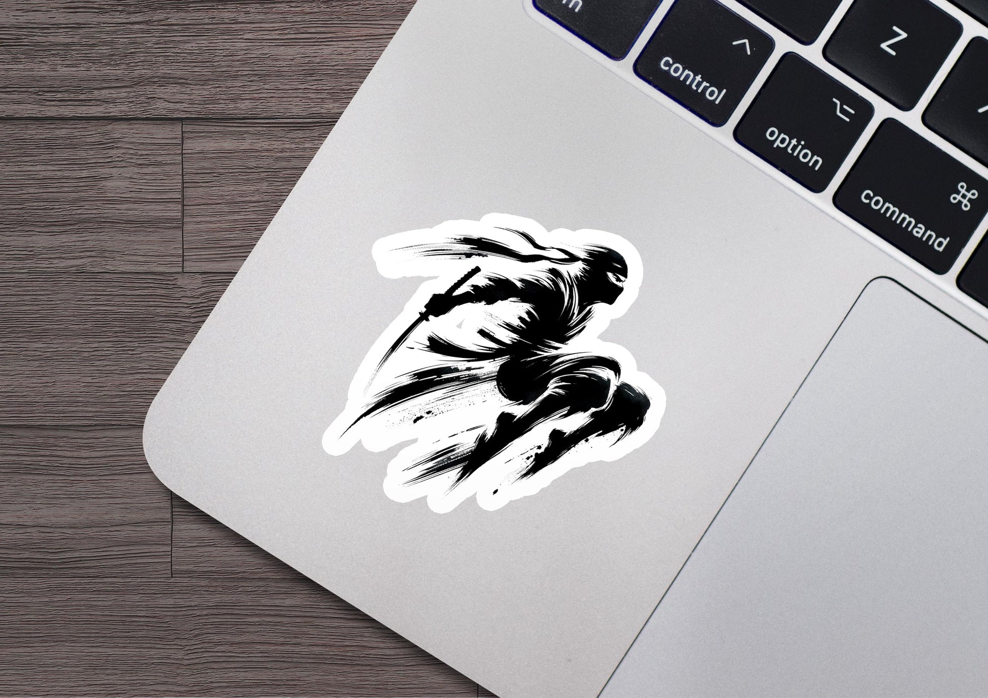 a laptop with a sticker of a man running