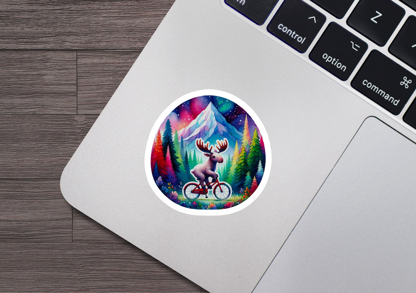 a laptop with a sticker of a moose riding a bike