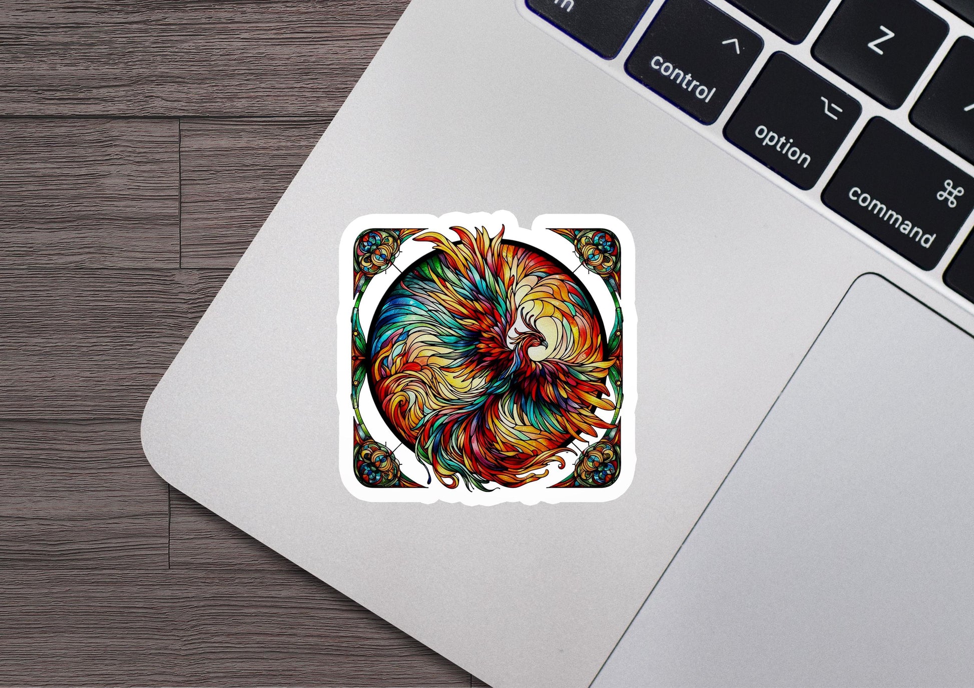 a sticker of a colorful bird on a laptop