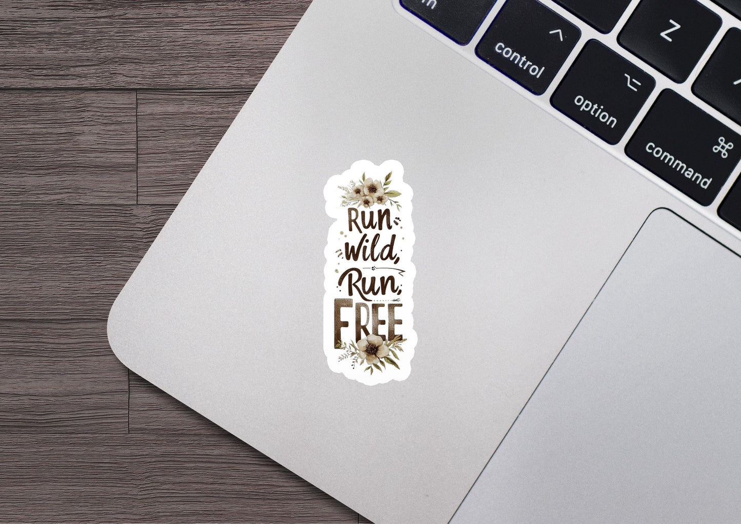 a sticker that says run wild run free on a laptop