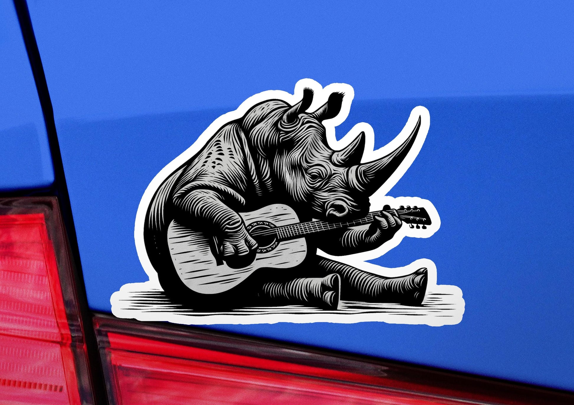 a sticker of a rhino playing a guitar