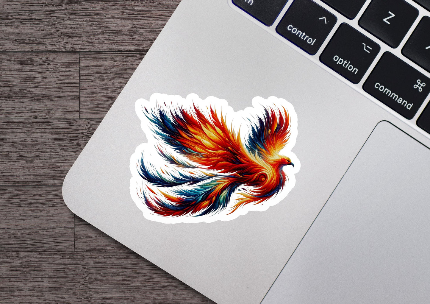 a sticker of a colorful bird on a laptop