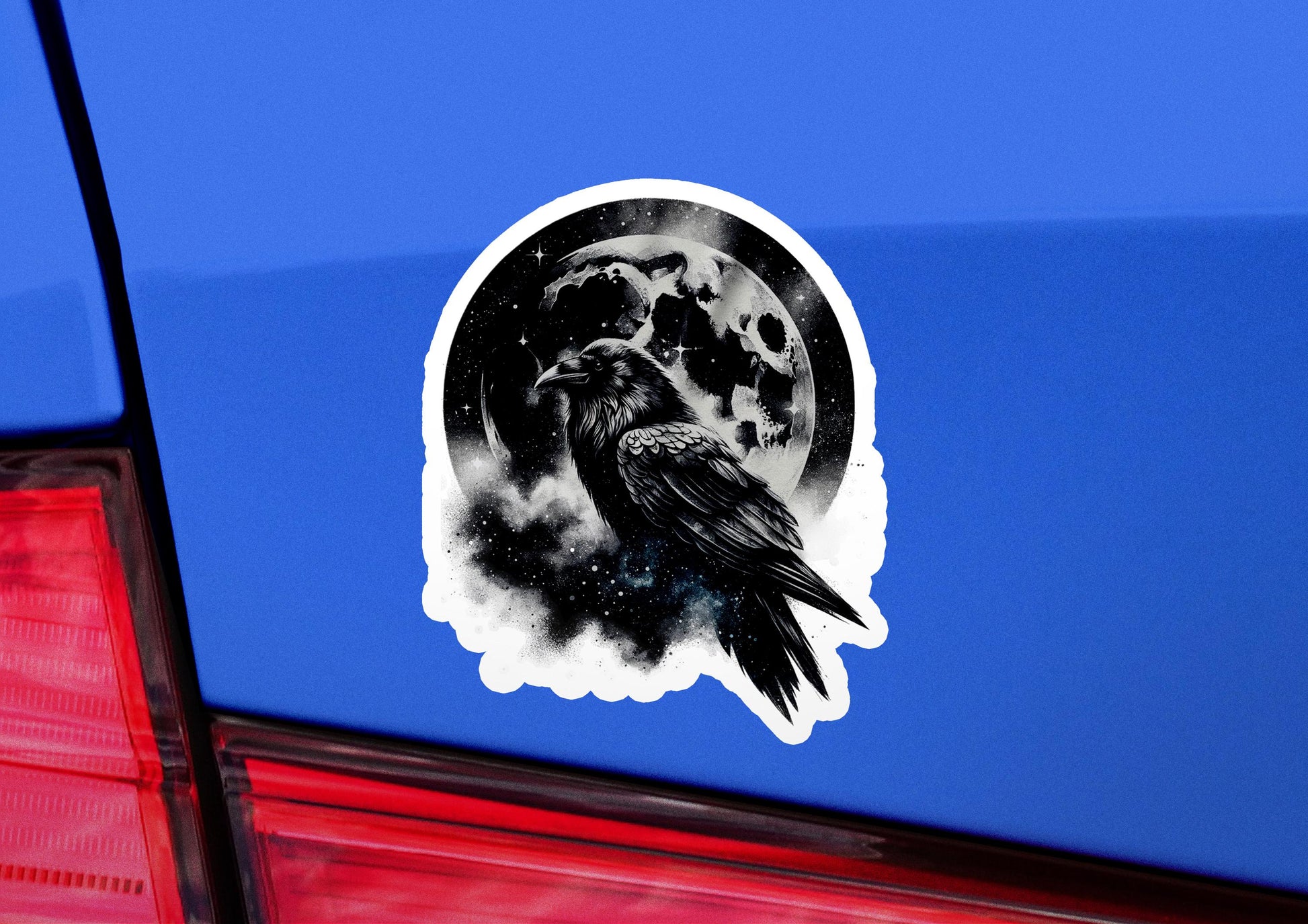 a sticker of a crow sitting on the tail of a car