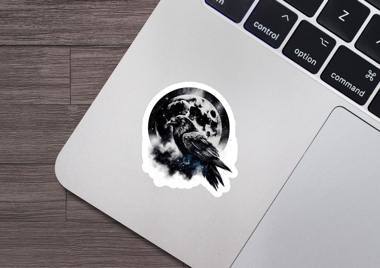 a laptop with a sticker of a bird on it