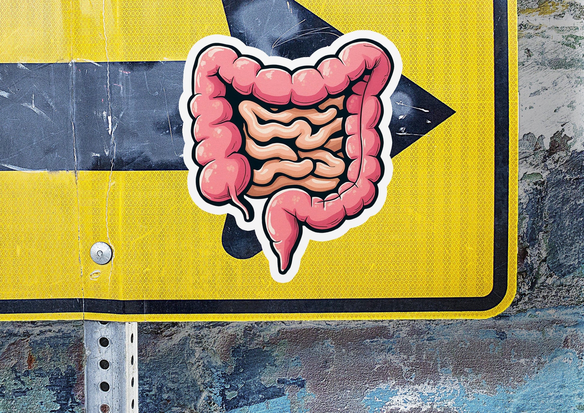 a sticker of a stomach on a yellow street sign