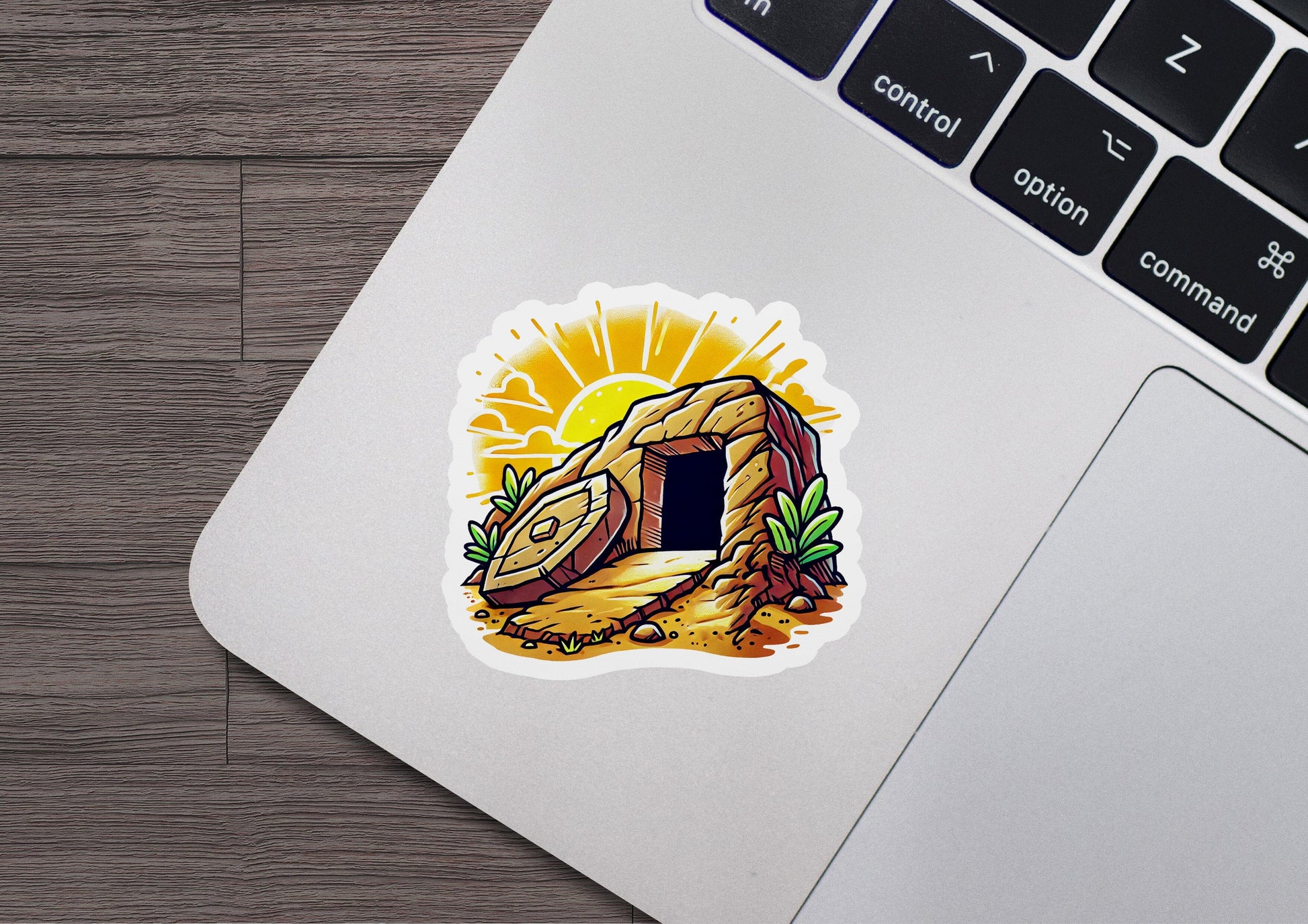 a laptop with a sticker of a cave