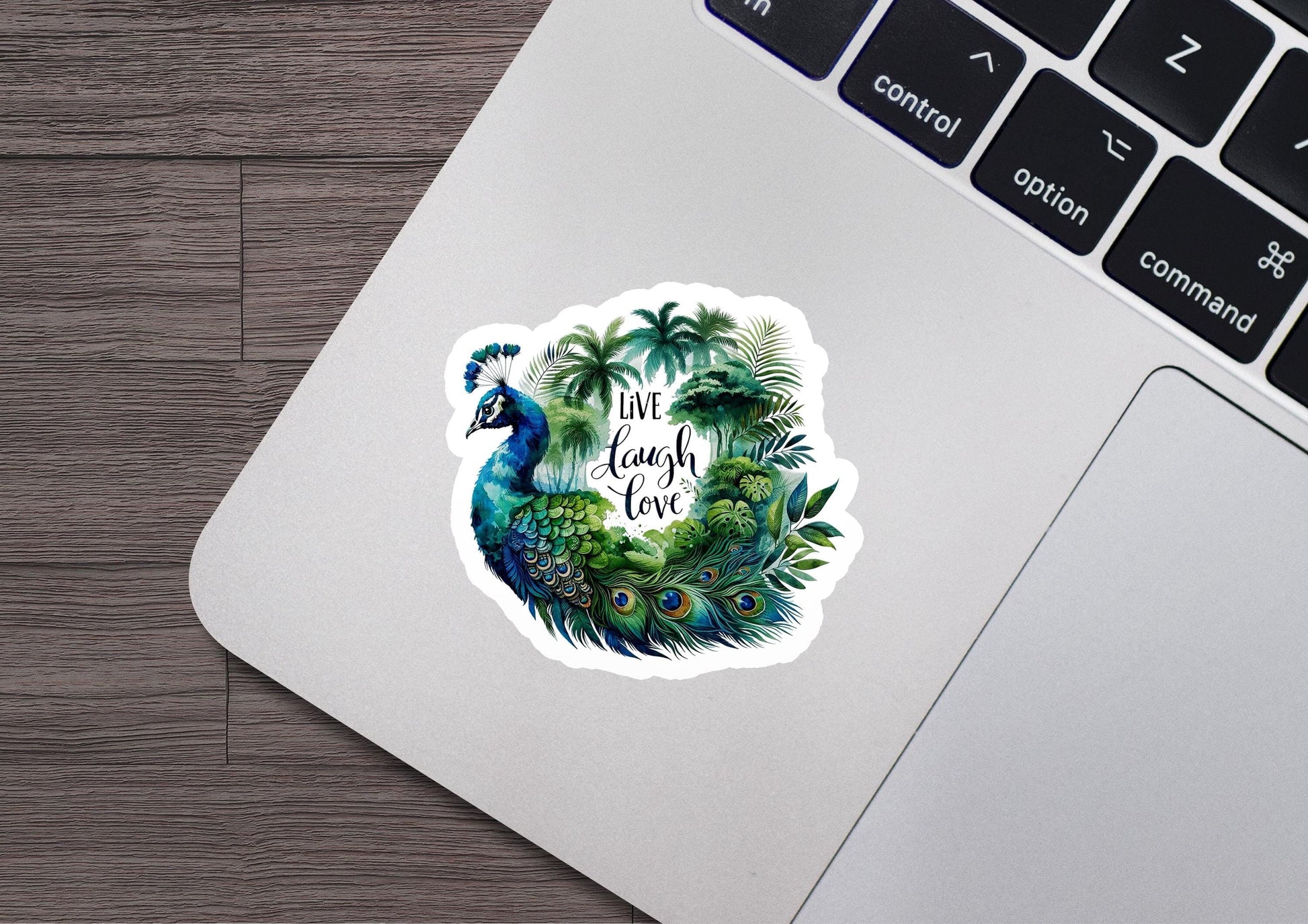 a laptop with a sticker of a peacock and palm trees