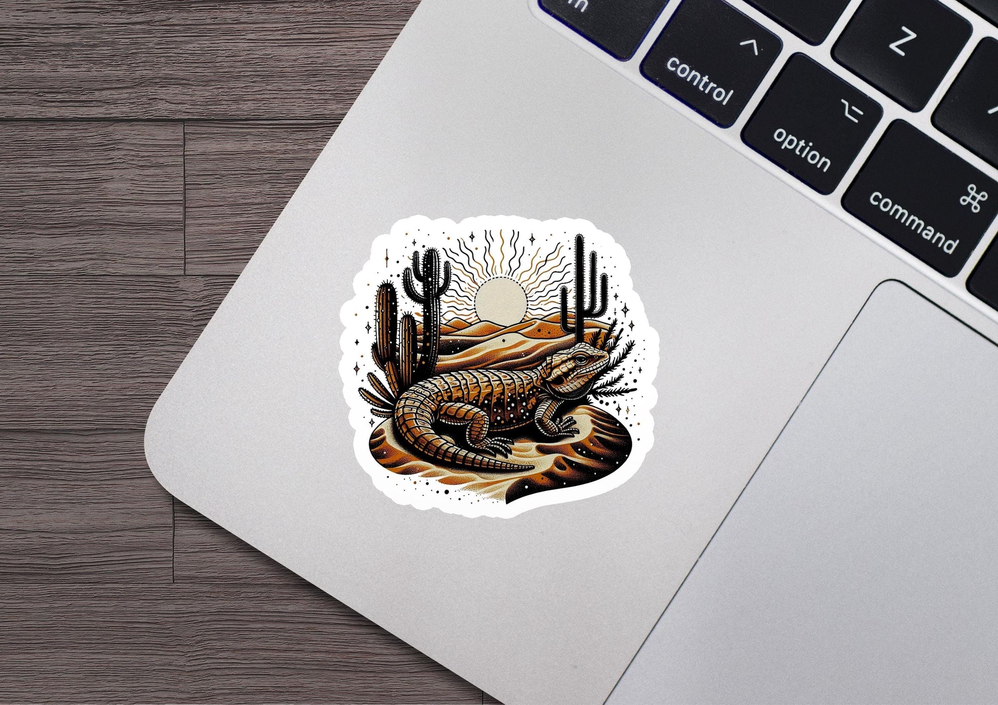 a laptop with a sticker of a lizard on it