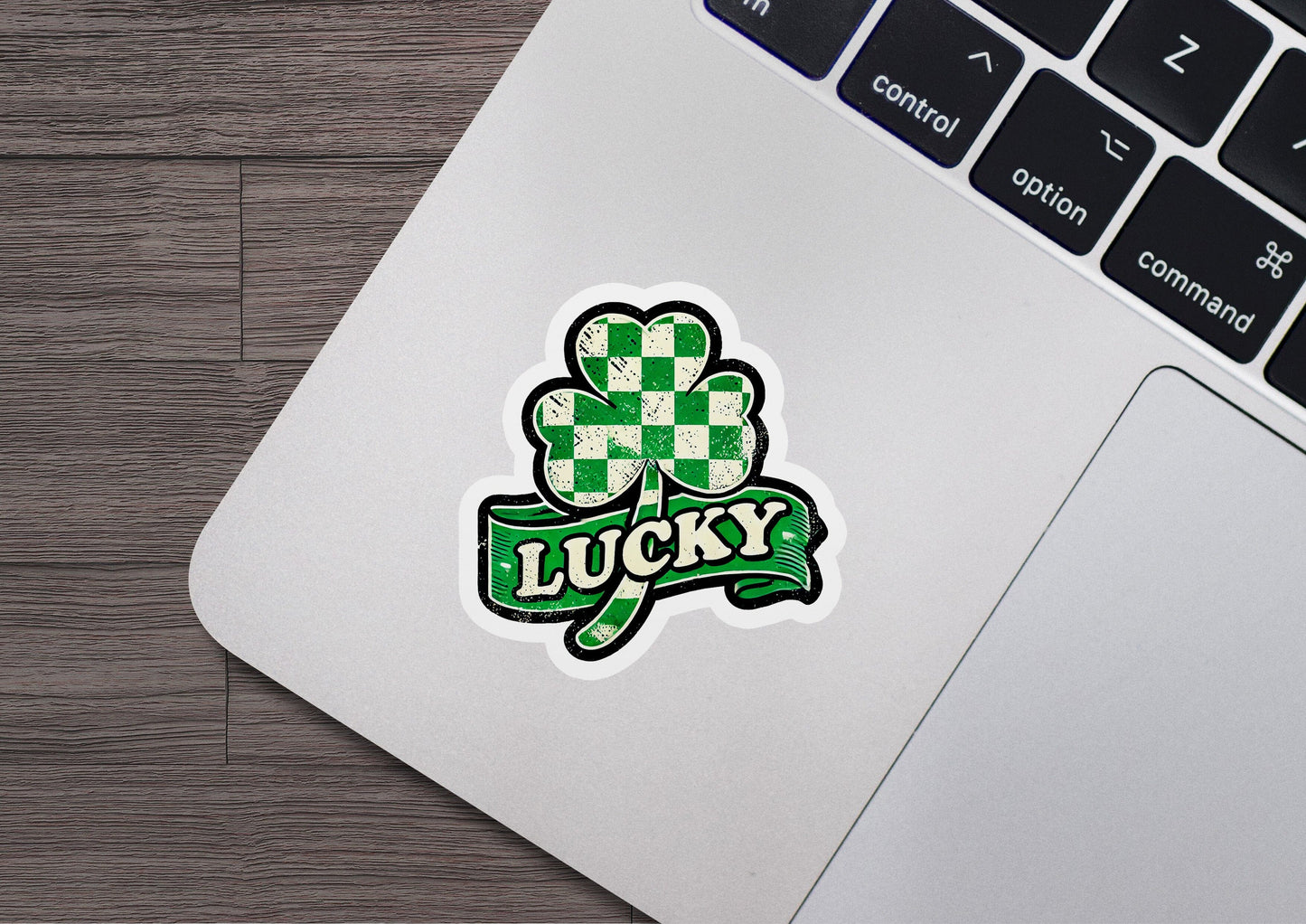 a laptop computer with a sticker of a clover