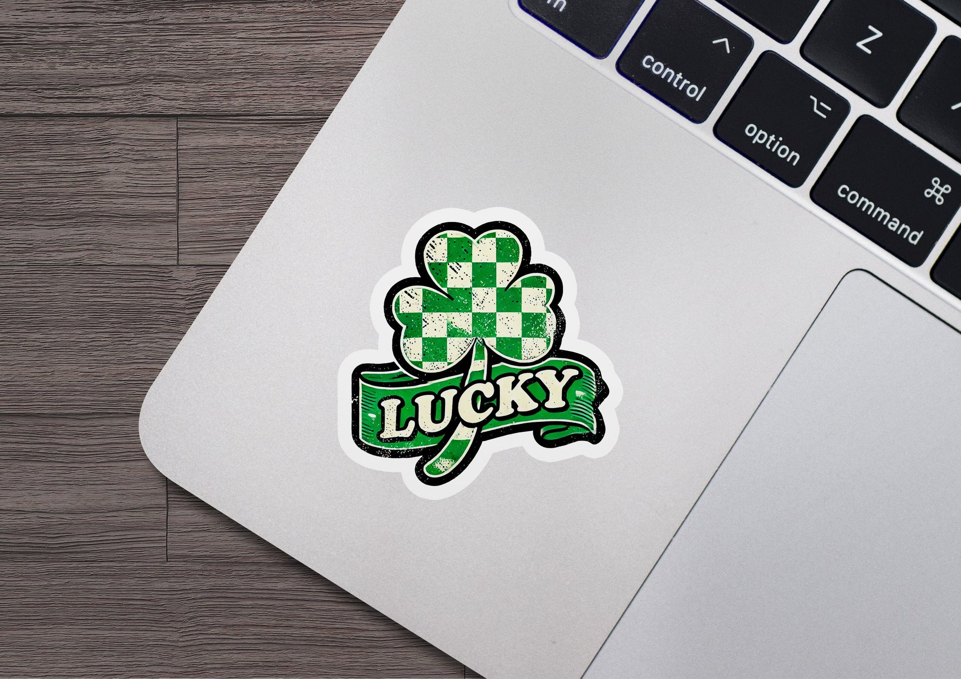 a laptop computer with a sticker of a clover