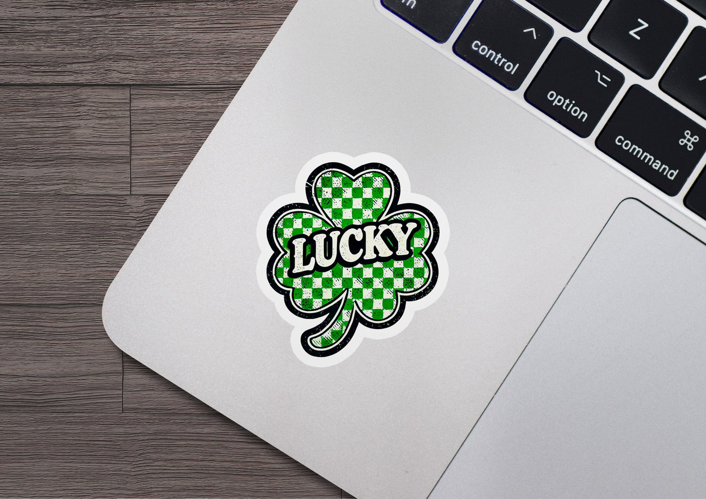 a laptop computer with a sticker of a clover