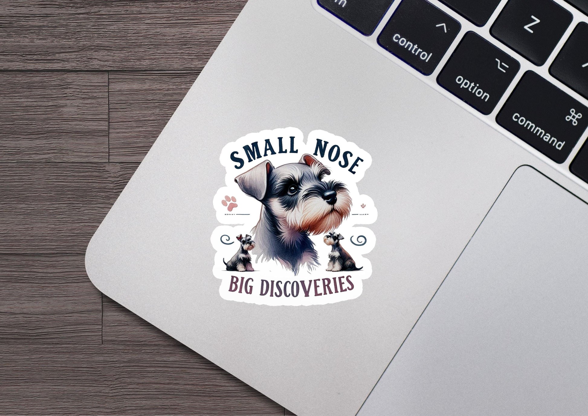 a sticker of a small dog on a laptop