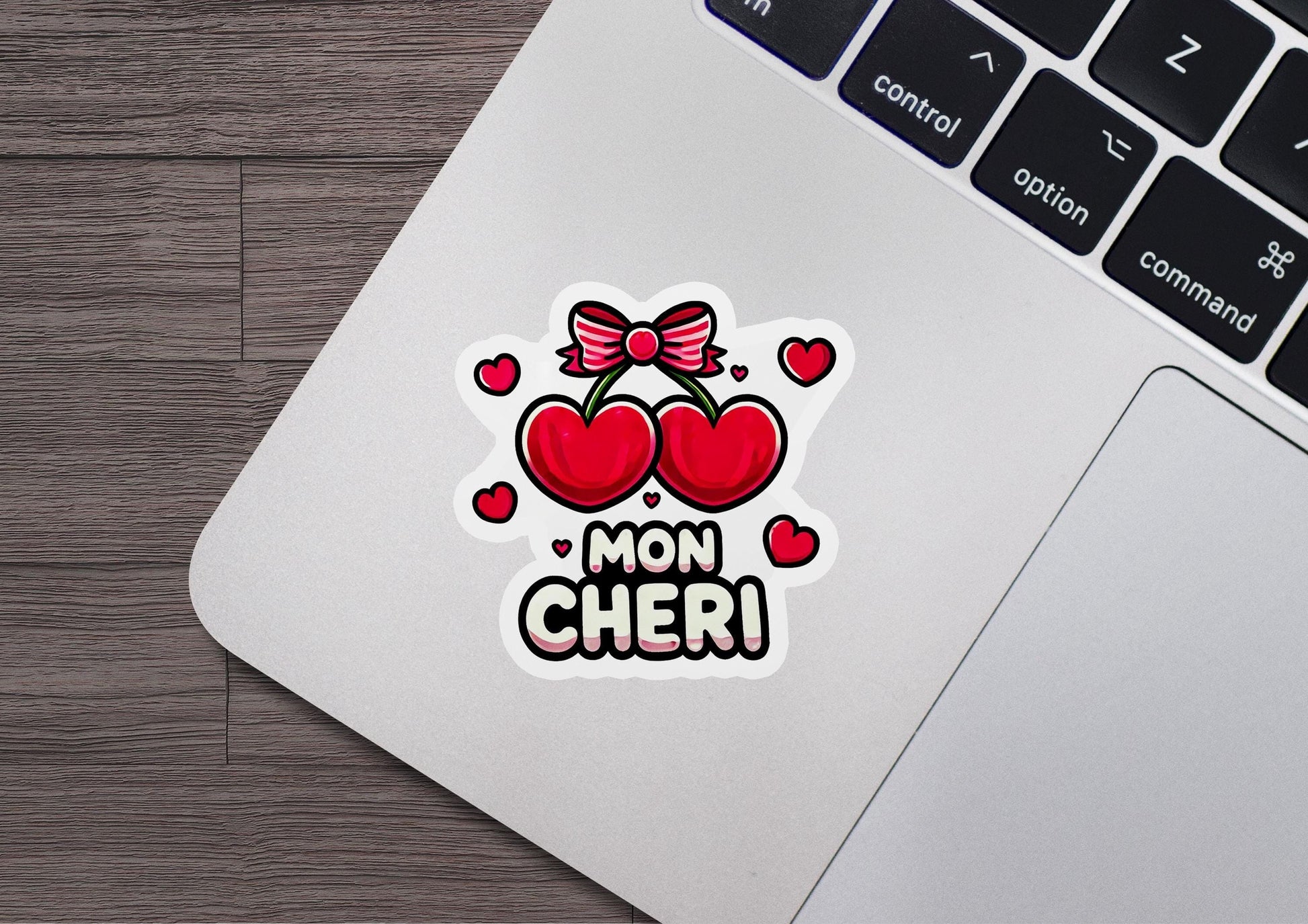 a laptop with a sticker of two hearts on it