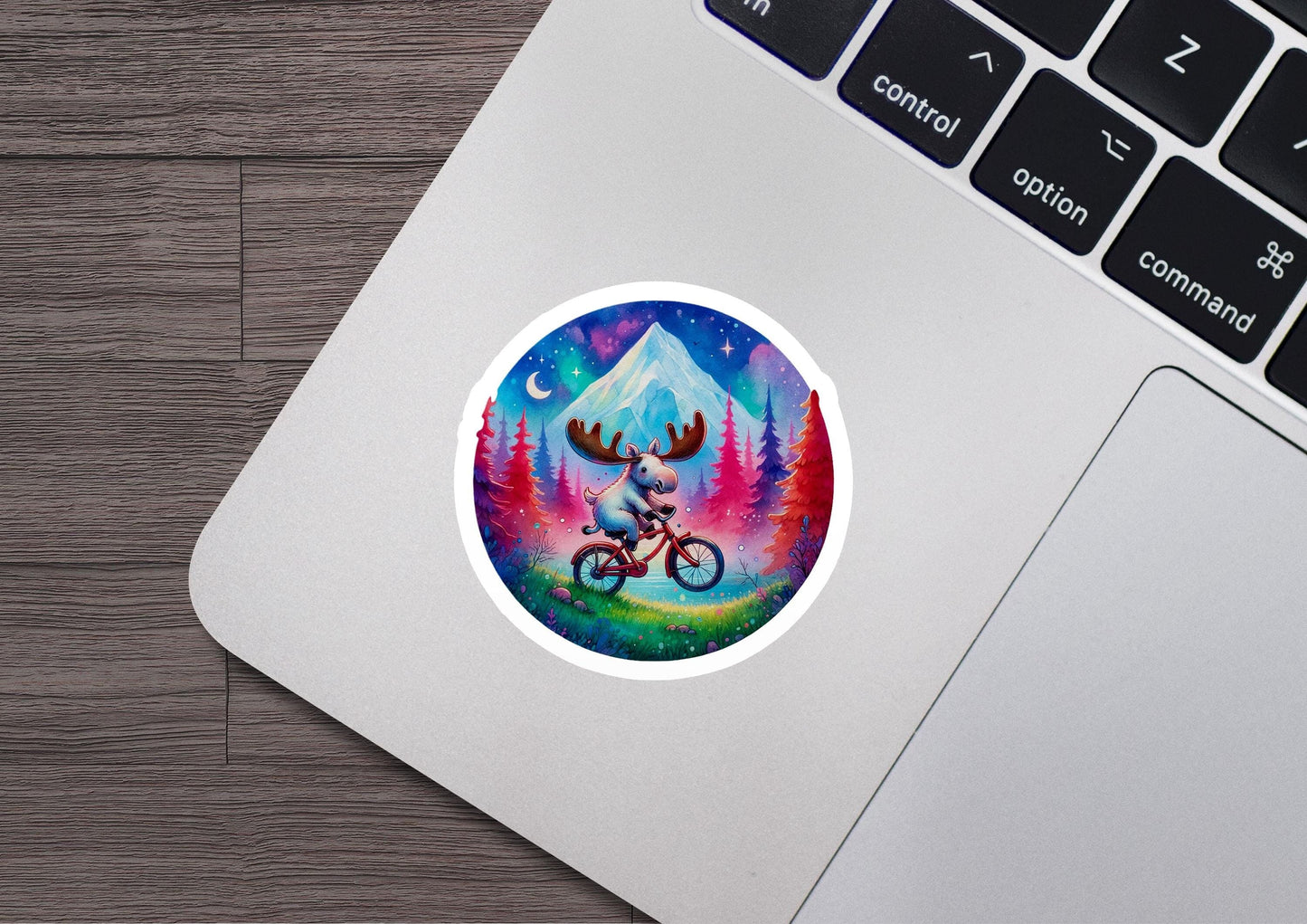 a laptop with a sticker of a moose riding a bike