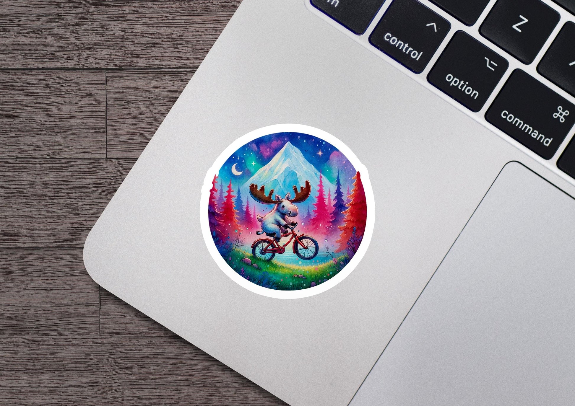 a laptop with a sticker of a moose riding a bike