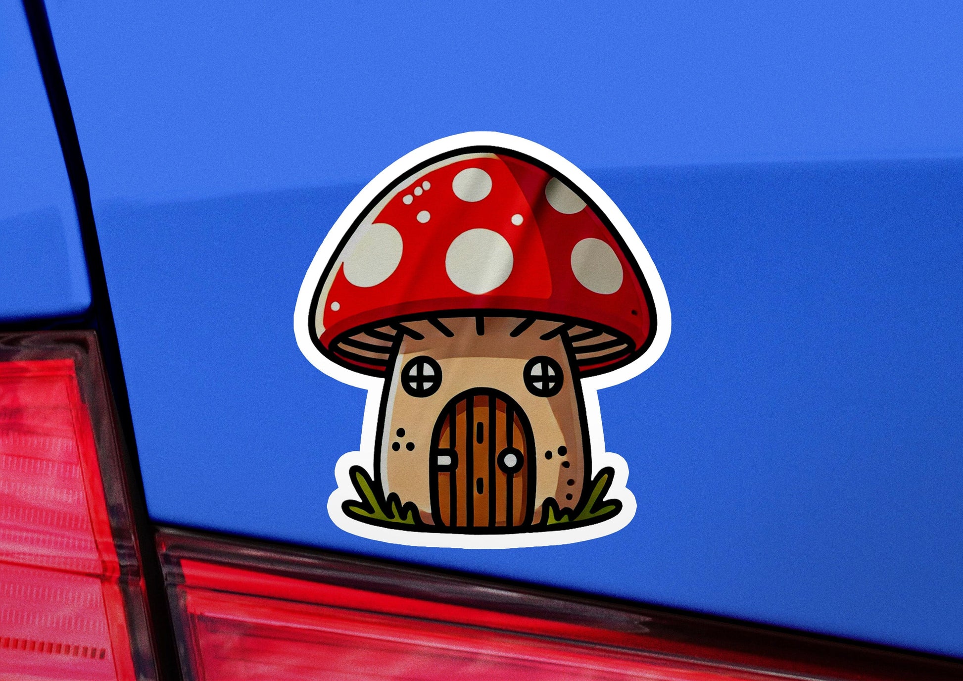 a sticker of a mushroom house on the back of a car