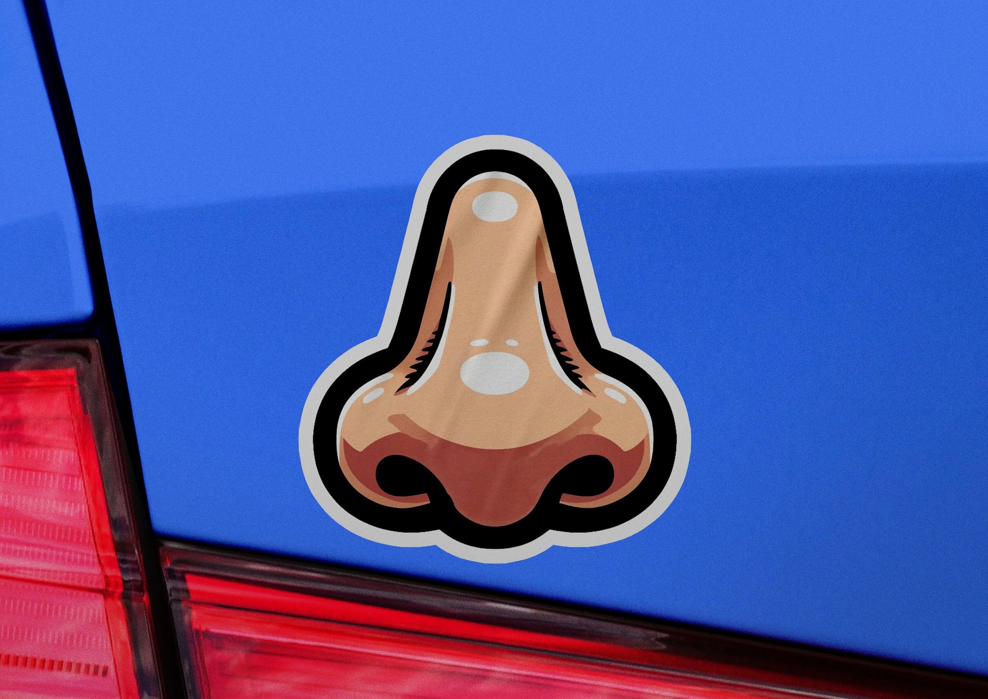 a close up of a car with a sticker of a nose