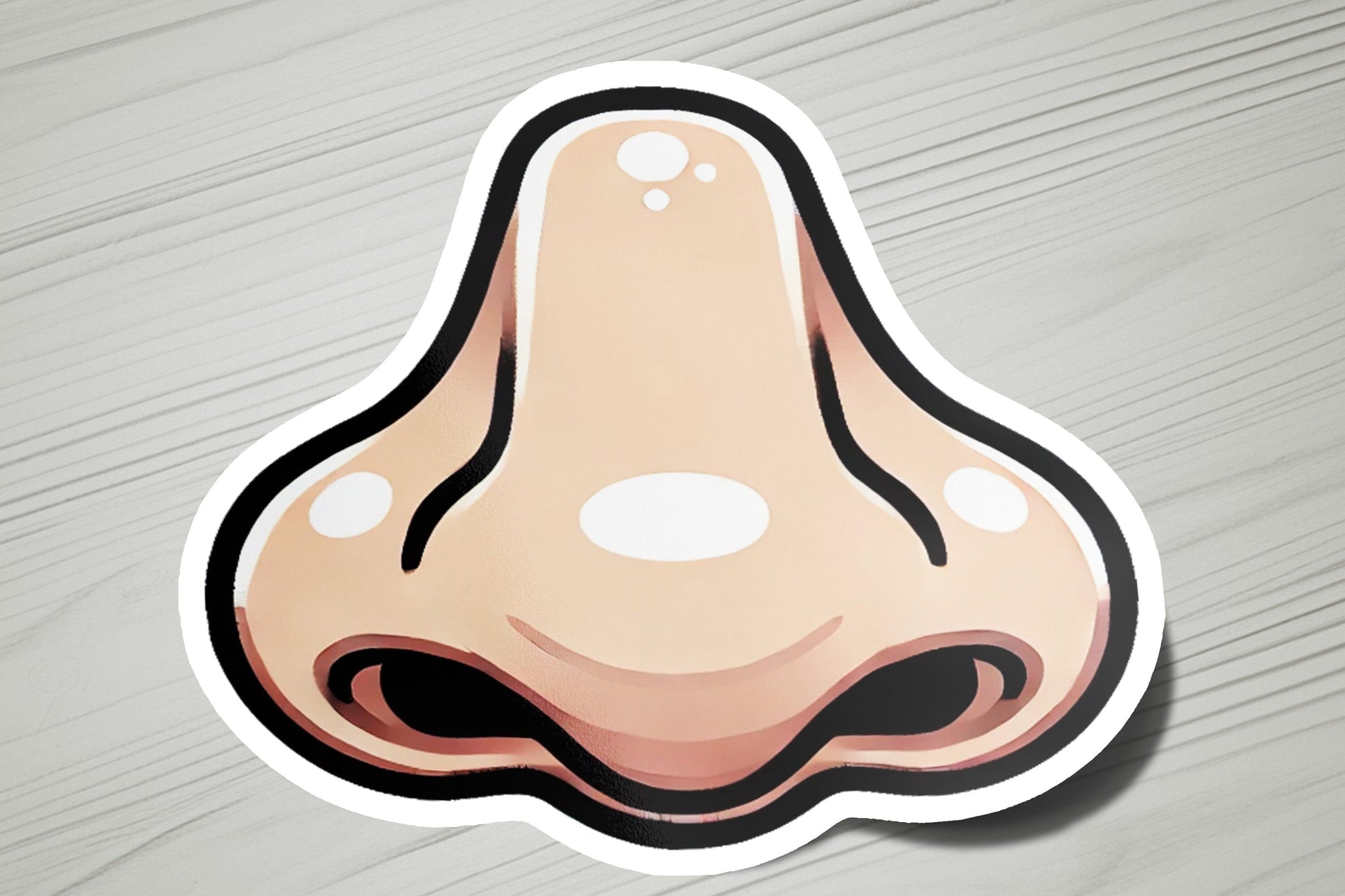 a sticker of a nose on a wooden surface