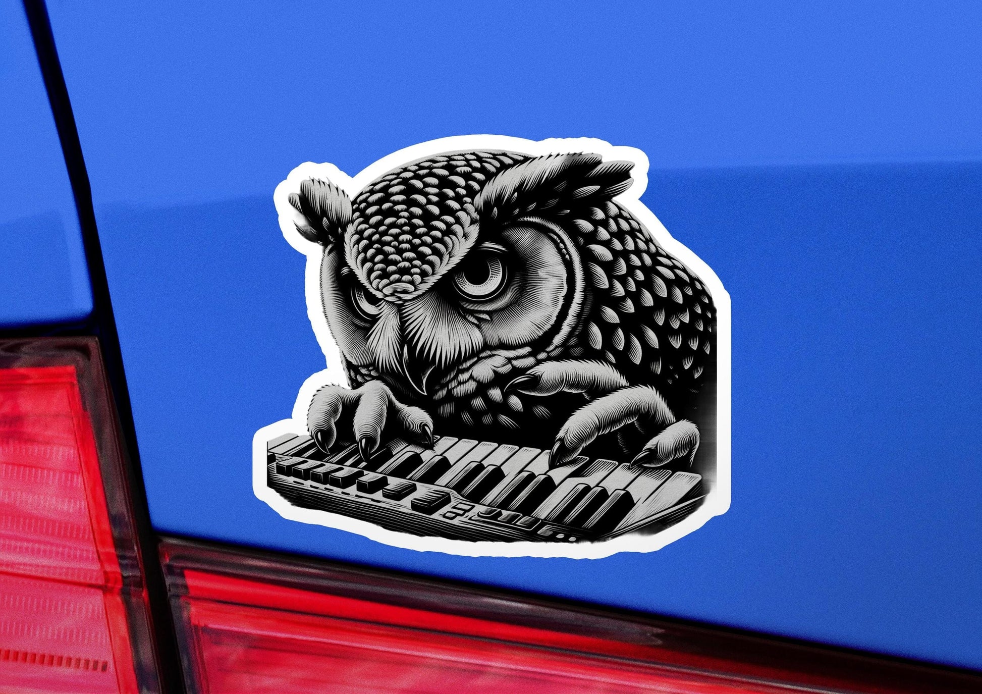 a sticker of an owl playing a keyboard