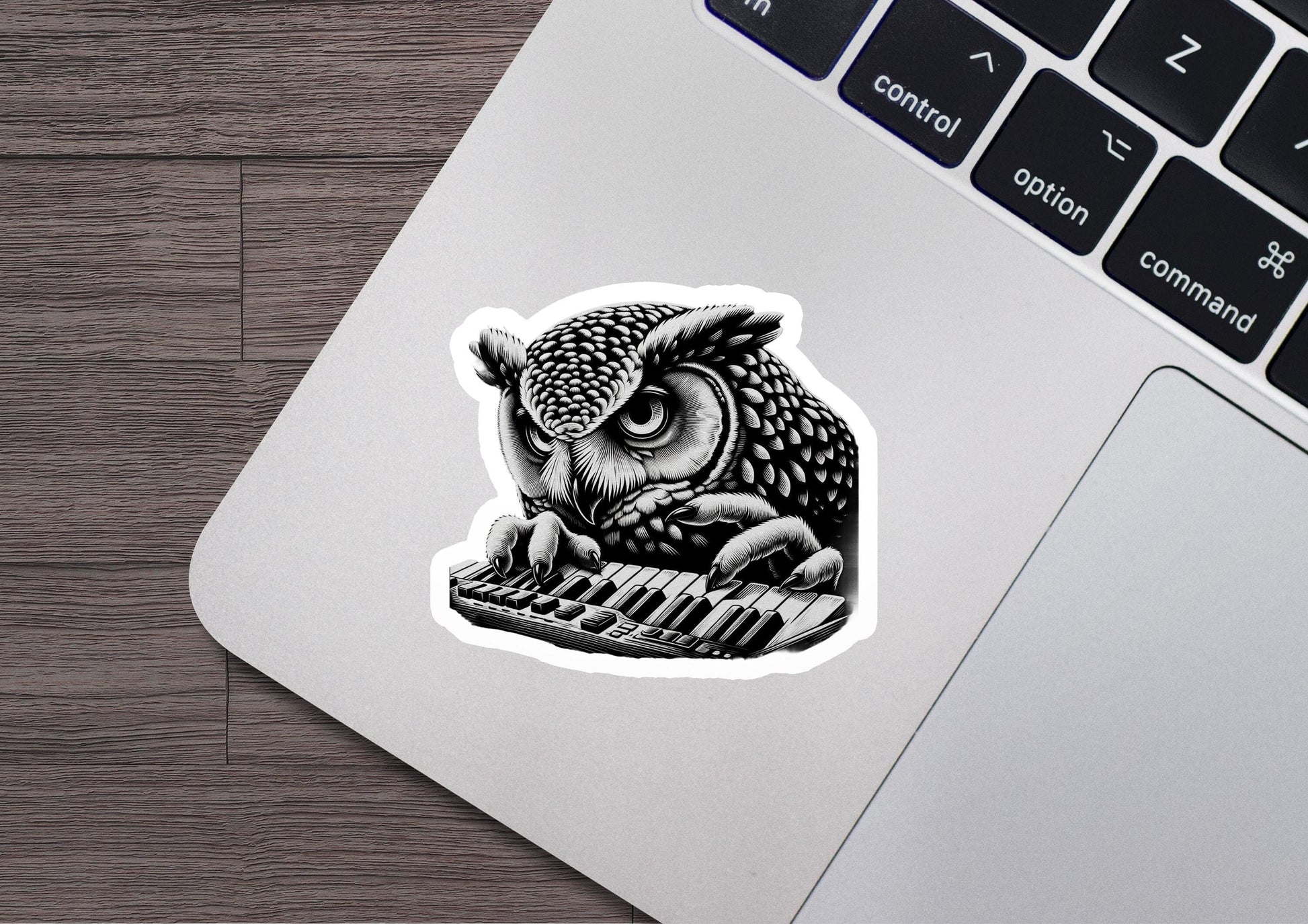 a sticker of an owl sitting on a keyboard
