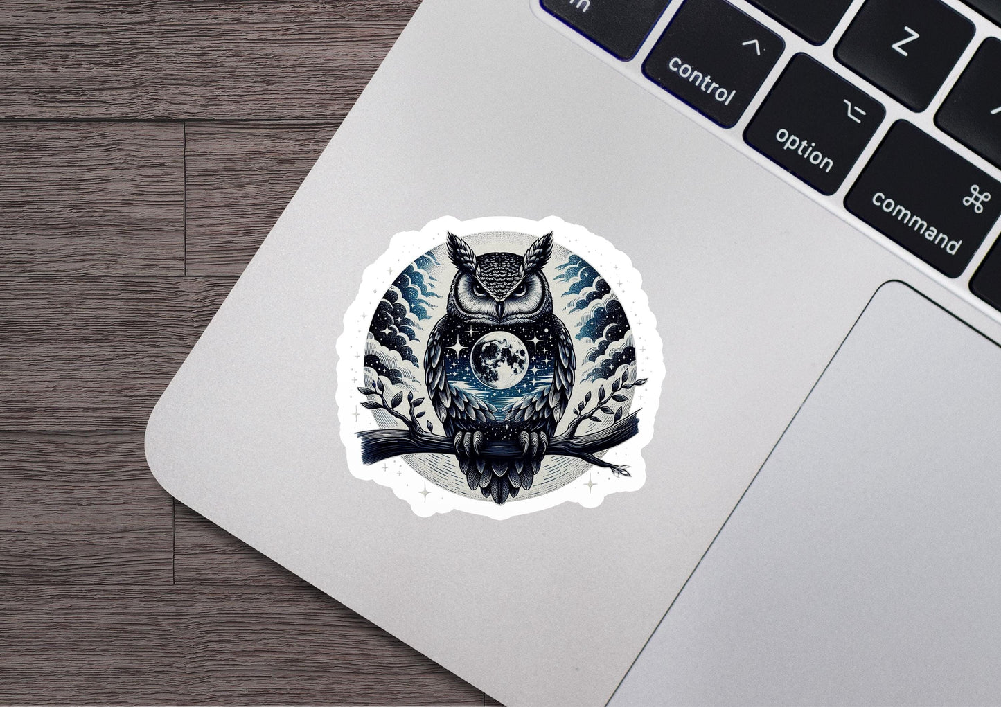 a laptop with a sticker of an owl on it