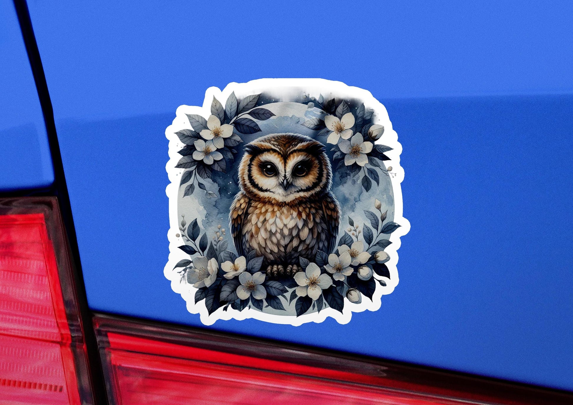 an owl sticker on the back of a car