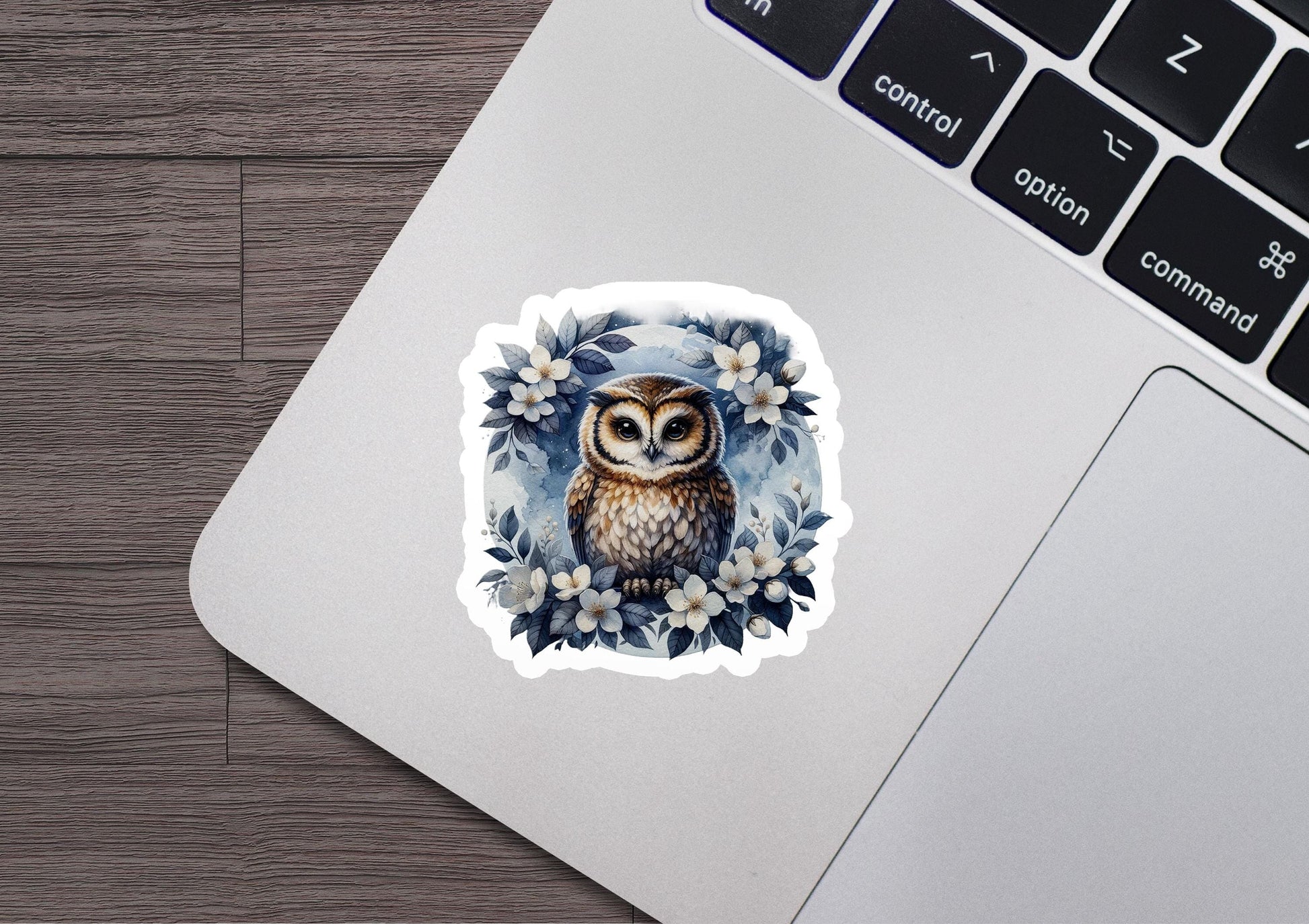 a sticker of an owl sitting on top of a laptop