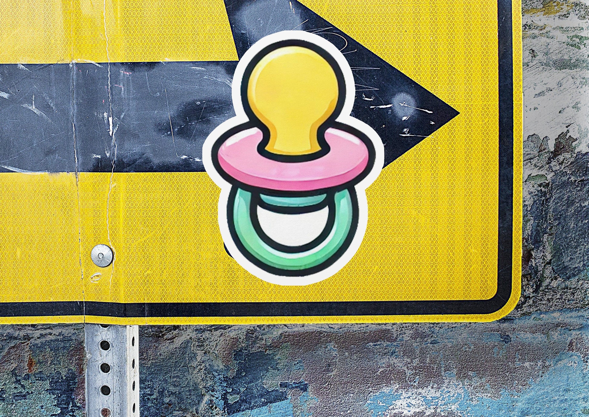 a street sign with a pacifier sticker on it